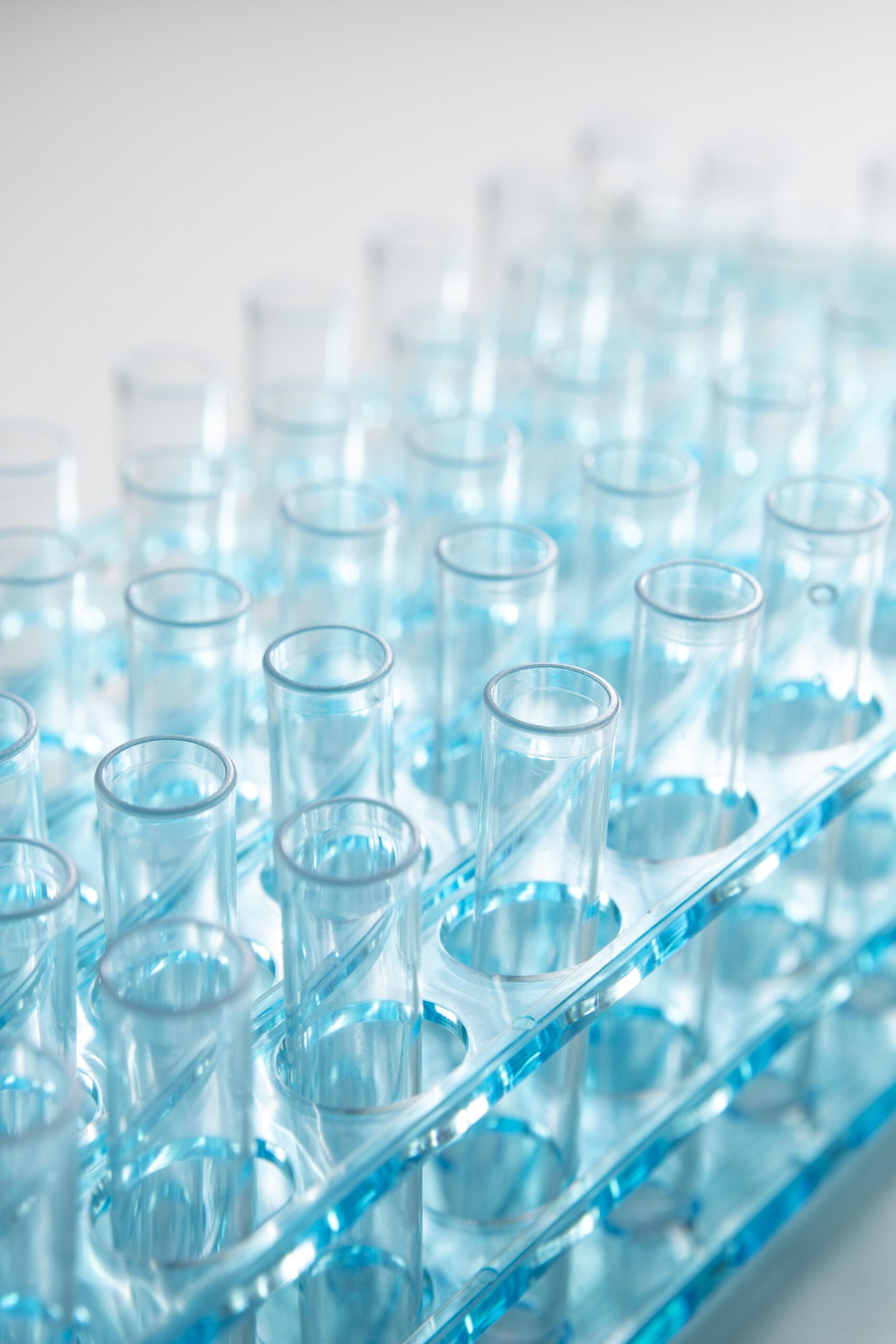 A still-life arrangement of test tubes filled with various liquids, representing quality control and laboratory testing in the pharmaceutical or scientific industry.