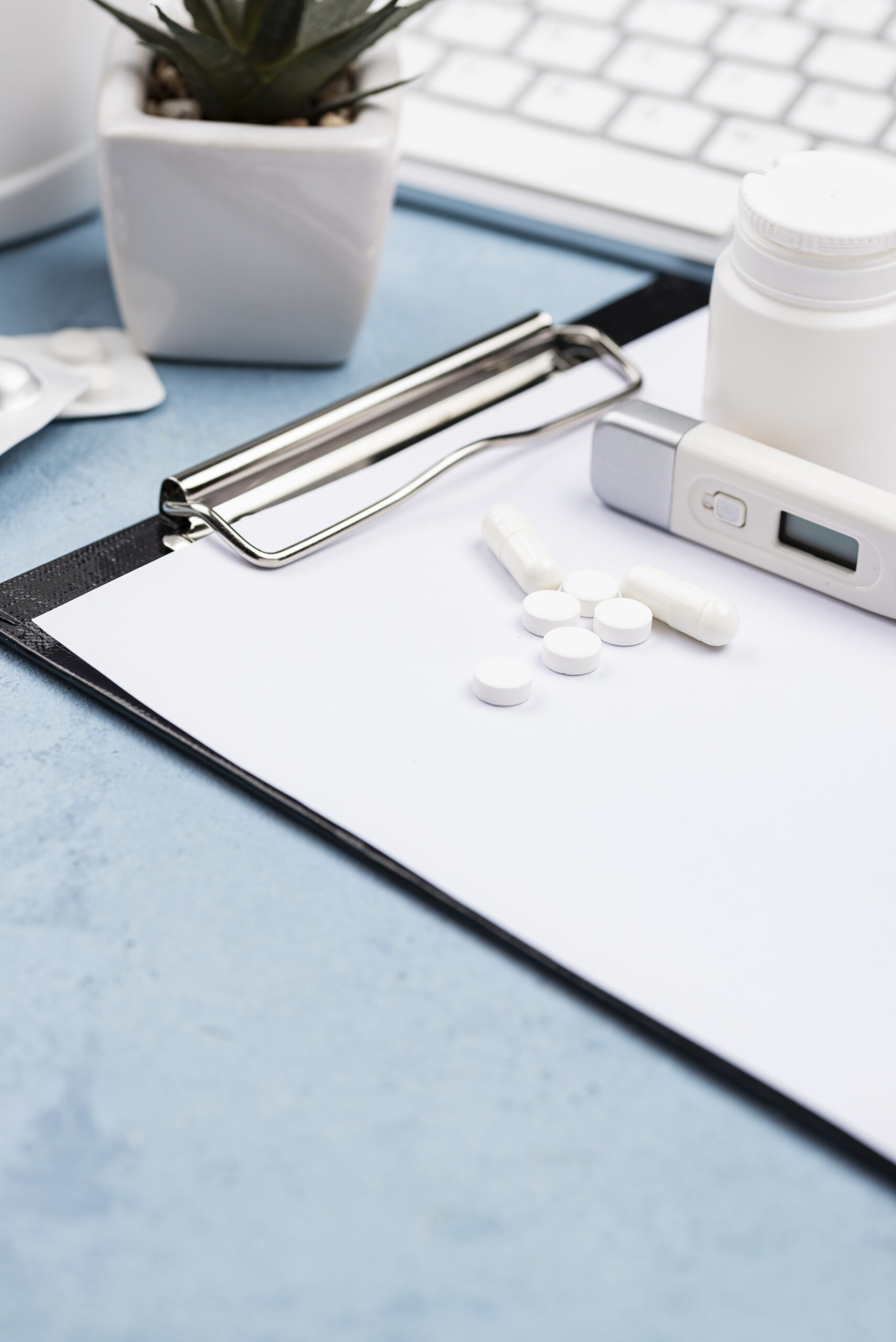 High-angle view of various medical and educational objects arranged neatly on a surface, including lab instruments and textbooks, symbolizing the intersection of learning and healthcare.